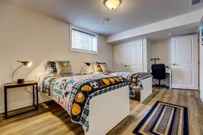 a bedroom with a bed and a desk at GLOBALSTAY New Basement 4 Bd in Port Elgin in Port Elgin
