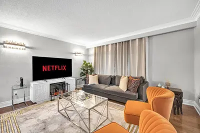 a living room with a couch and a tv at Modern 5BR Home with Office and Parking and WiFi in Oakville