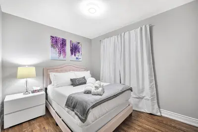 a bed with two teddy bears on it in a bedroom at Modern 5BR Home with Office and Parking and WiFi in Oakville