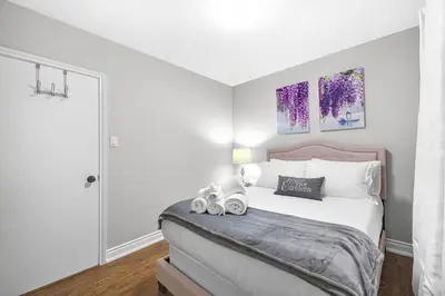 a bedroom with a bed with two stuffed animals on it at Modern 5BR Home with Office and Parking and WiFi in Oakville