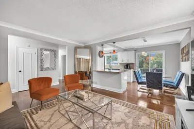 a living room with chairs and a table at Modern 5BR Home with Office and Parking and WiFi in Oakville