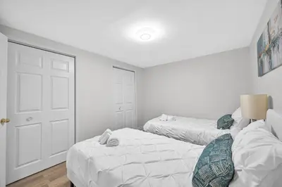 a bedroom with two beds and a white door at Modern 5BR Home with Office and Parking and WiFi in Oakville