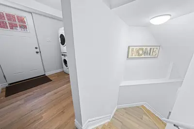 a white room with a door and a sign on the wall at Charming 1-bed basement, Wi-Fi in Barrie