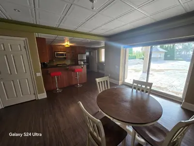 a kitchen and dining room with a table and chairs at Chez Mason in Richmond Hill