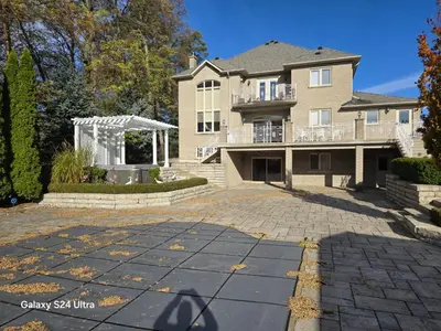 a large house with a driveway in front of it at Chez Mason in Richmond Hill