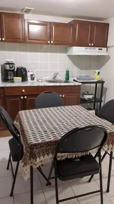 a kitchen with a table with four chairs and a counter at Whole House Fair Price Great Amenities in Richmond Hill