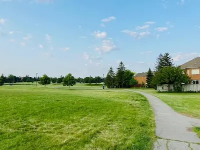 a field of green grass with a path at Sunnys Home Stays 1 Bedroom Bath & Kitchenette Toronto Mississauga At Erin Mills With Pvt Entrance in Mississauga