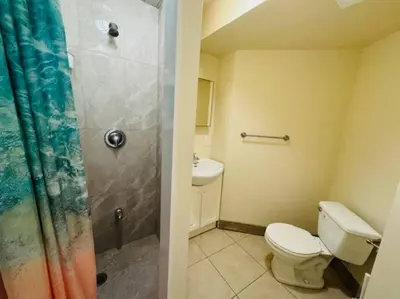 a small bathroom with a toilet and a shower at Sunnys Home Stays 1 Bedroom Bath & Kitchenette Toronto Mississauga At Erin Mills With Pvt Entrance in Mississauga