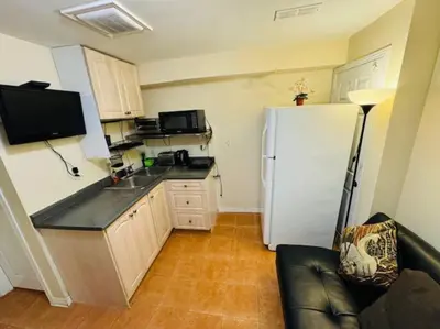 a kitchen with a white refrigerator and a black counter top at Sunnys Home Stays 1 Bedroom Bath & Kitchenette Toronto Mississauga At Erin Mills With Pvt Entrance in Mississauga