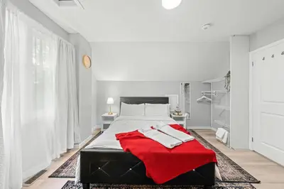 a bedroom with a bed with a red blanket on it at Private Cozy Room with Free Parking in Toronto
