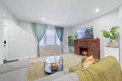 a living room with a couch and a fireplace at Private Cozy Room with Free Parking in Toronto