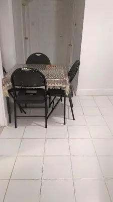 a table and two chairs on a white tiled floor at Multiple Fair Price Great Amenities Rooms in Richmond Hill