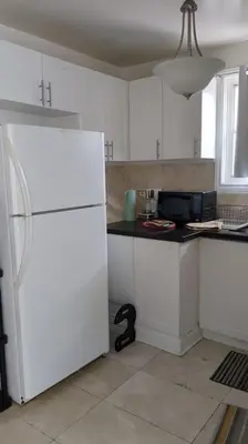 a kitchen with white cabinets and a white refrigerator at Multiple Fair Price Great Amenities Rooms in Richmond Hill