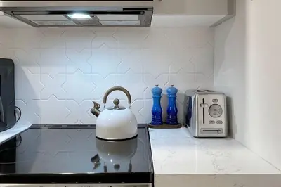 a kitchen counter with a tea kettle and a toaster at Fresh and Modern Guest Suite in Toronto