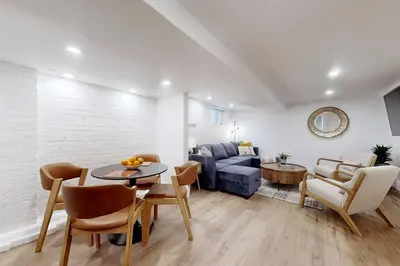 a living room with a couch and a table at Fresh and Modern Guest Suite in Toronto