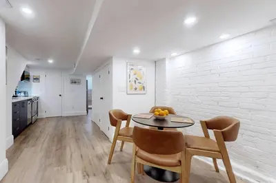 a kitchen and dining room with a table and chairs at Fresh and Modern Guest Suite in Toronto