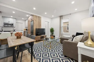 a living room with a couch and a table at Private House with parking & steps to subway in Toronto