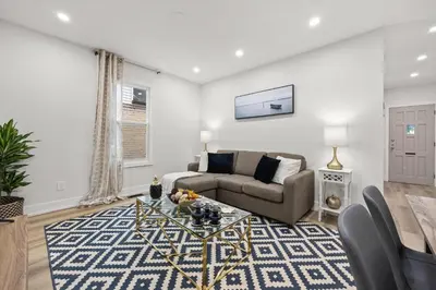 a living room with a couch and a table at Private House with parking & steps to subway in Toronto