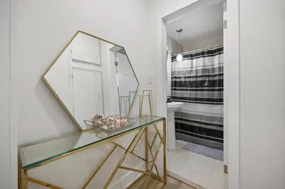 a bathroom with a glass table with a mirror at Private House with parking & steps to subway in Toronto