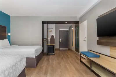 a hotel room with a bed and a flat screen tv at Tru By Hilton Bracebridge, On in Bracebridge