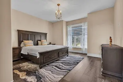 a bedroom with a large bed and a window at Private Farmhouse Getaway with hot tub in Waterloo