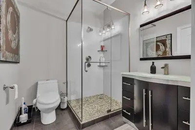 a bathroom with a shower and a toilet and a sink at Private Farmhouse Getaway with hot tub in Waterloo