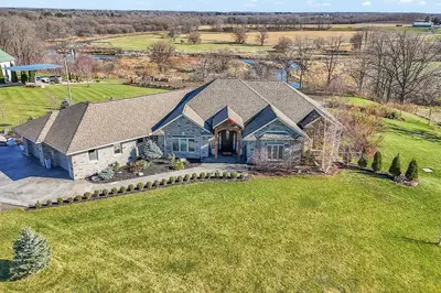 an aerial view of a house with a large yard at Private Farmhouse Getaway with hot tub in Waterloo