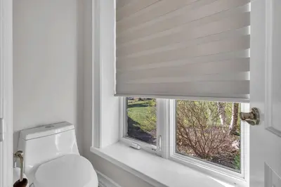 a bathroom with a toilet and a window at Private Farmhouse Getaway with hot tub in Waterloo