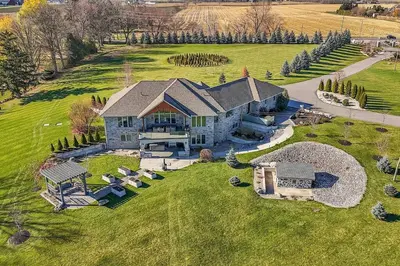 an aerial view of a large house on a green field at Private Farmhouse Getaway with hot tub in Waterloo
