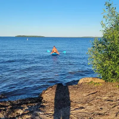 a man in a kayak in the water at ARCA Cozy Cabin-Innisfil Beach in Innisfil