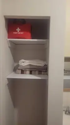 a closet with a shelf with a red box on it at ARCA Cozy Cabin-Innisfil Beach in Innisfil