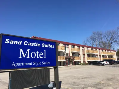 a blue sign in front of a building at Sand Castle Suites Motel in Port Elgin