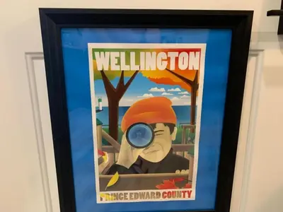 a framed poster of a man with a magnifying glass at County Cove - Wellington Suite - Two-Bedroom Wellington Apartment in Wellington