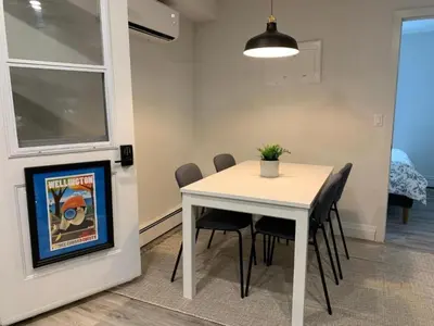 a dining room with a white table and chairs at County Cove - Wellington Suite - Two-Bedroom Wellington Apartment in Wellington