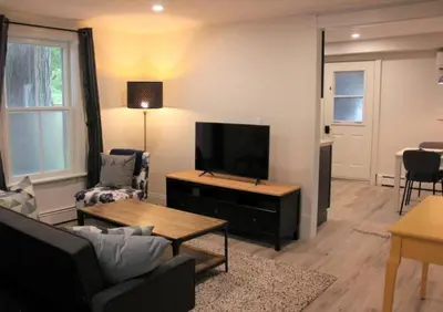 a living room with a couch and a tv at County Cove - Wellington Suite - Two-Bedroom Wellington Apartment in Wellington