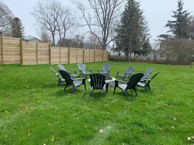a group of chairs and a table in the grass at County Cove - Wellington Suite - Two-Bedroom Wellington Apartment in Wellington