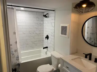 a bathroom with a tub and a toilet and a sink at County Cove - Picton Suite - downtown Wellington in Wellington