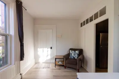 a living room with a chair and a window at County Cove - Picton Suite - downtown Wellington in Wellington