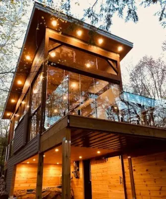 a glass house with lights on top of it at Muskoka Charm Beautiful four bedroom cottage in Gravenhurst