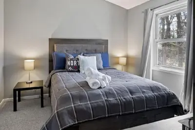 a bedroom with a bed with a teddy bear on it at Muskoka Charm Beautiful four bedroom cottage in Gravenhurst