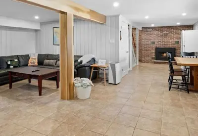 a living room with a couch and a table at Muskoka Charm Beautiful four bedroom cottage in Gravenhurst