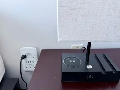 a lamp on a desk with a phone and a lamp at 44th Floor, Panoramic Views, Bay Corridor Downtown Toronto Condo in Toronto