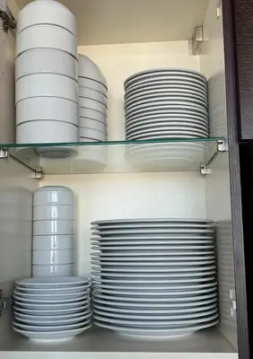 a bunch of plates are on a shelf at 44th Floor, Panoramic Views, Bay Corridor Downtown Toronto Condo in Toronto
