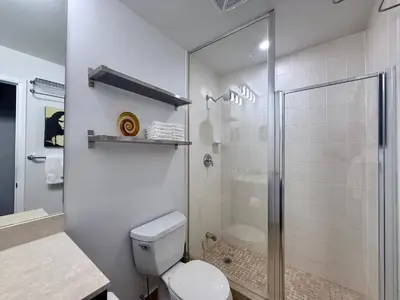 a white bathroom with a shower and a toilet at 44th Floor, Panoramic Views, Bay Corridor Downtown Toronto Condo in Toronto