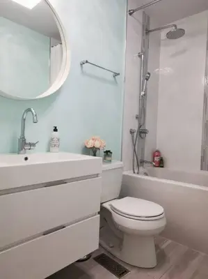 a bathroom with a toilet and a sink and a mirror at LakePark Artsy 3 bedroom Townhouse 1 Parking in Toronto