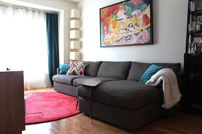 a living room with a couch and a red rug at LakePark Artsy 3 bedroom Townhouse 1 Parking in Toronto