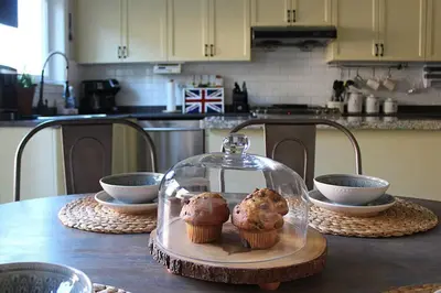 two muffins in a glass dome on a table at LakePark Artsy 3 bedroom Townhouse 1 Parking in Toronto