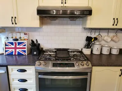 a kitchen with a stainless steel stove top oven at LakePark Artsy 3 bedroom Townhouse 1 Parking in Toronto