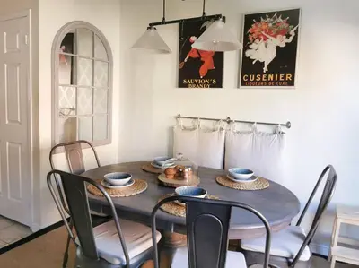 a dining room with a table and some chairs at LakePark Artsy 3 bedroom Townhouse 1 Parking in Toronto