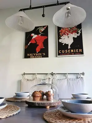 a table topped with plates and bowls and posters at LakePark Artsy 3 bedroom Townhouse 1 Parking in Toronto